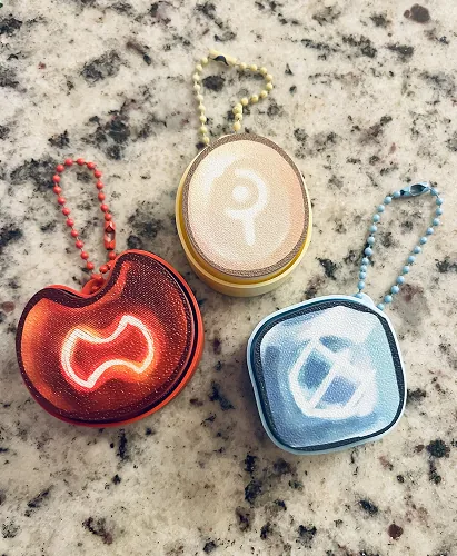 Three round shaped keychains with ball chains
