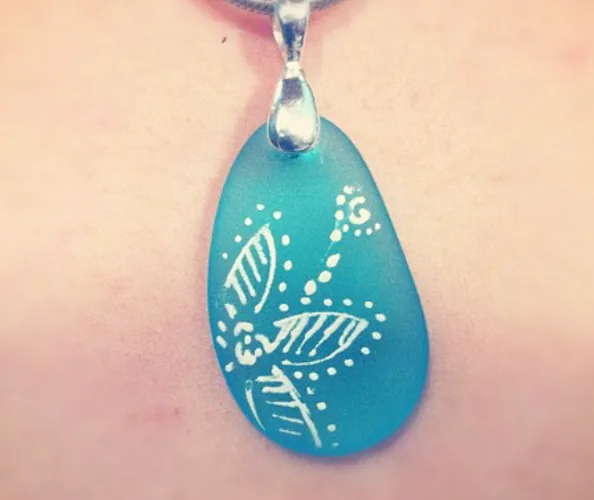 Teal sea glass pendant with hand-painted white floral design